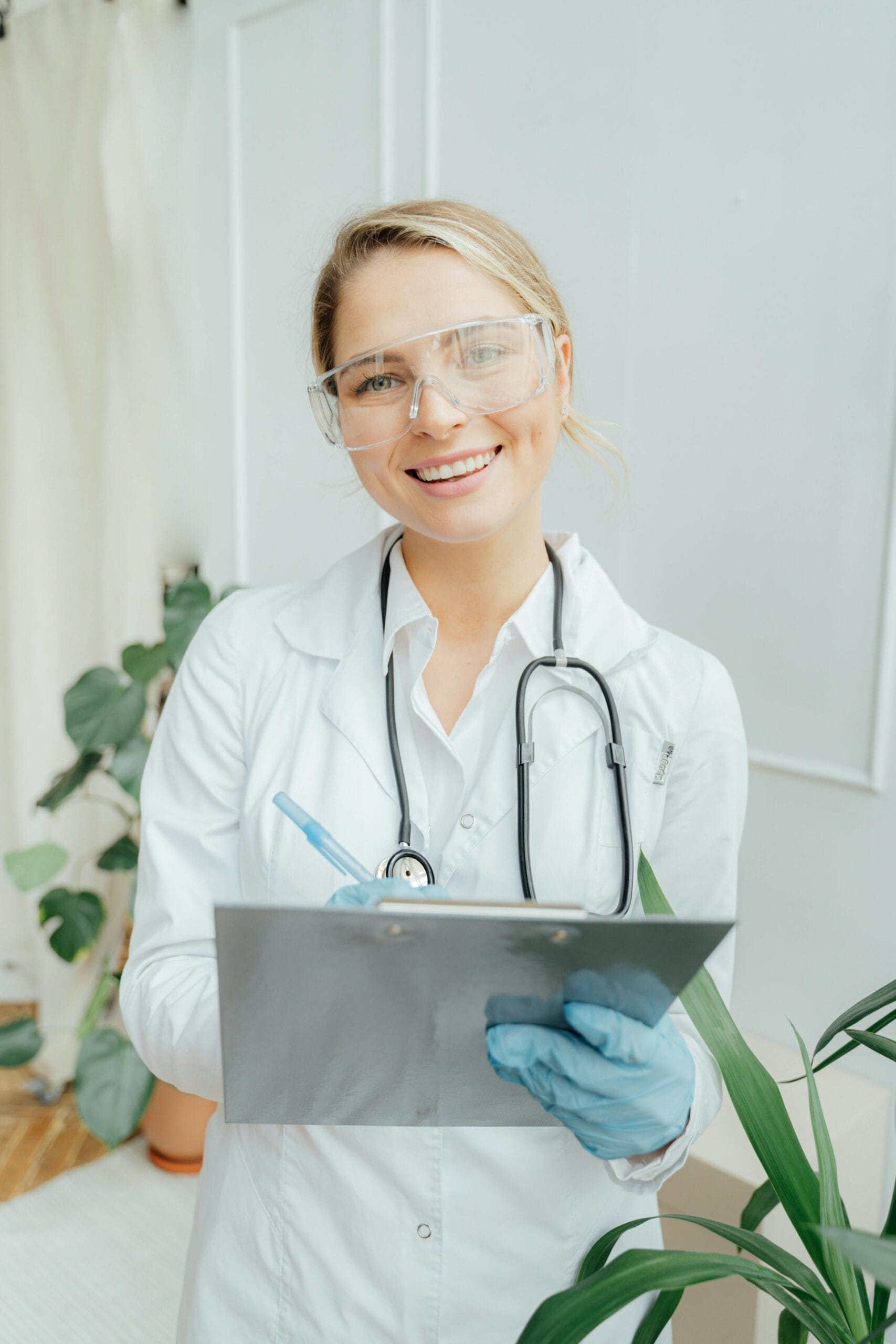 Home Confident female doctor with clipboard in a bright medical office.